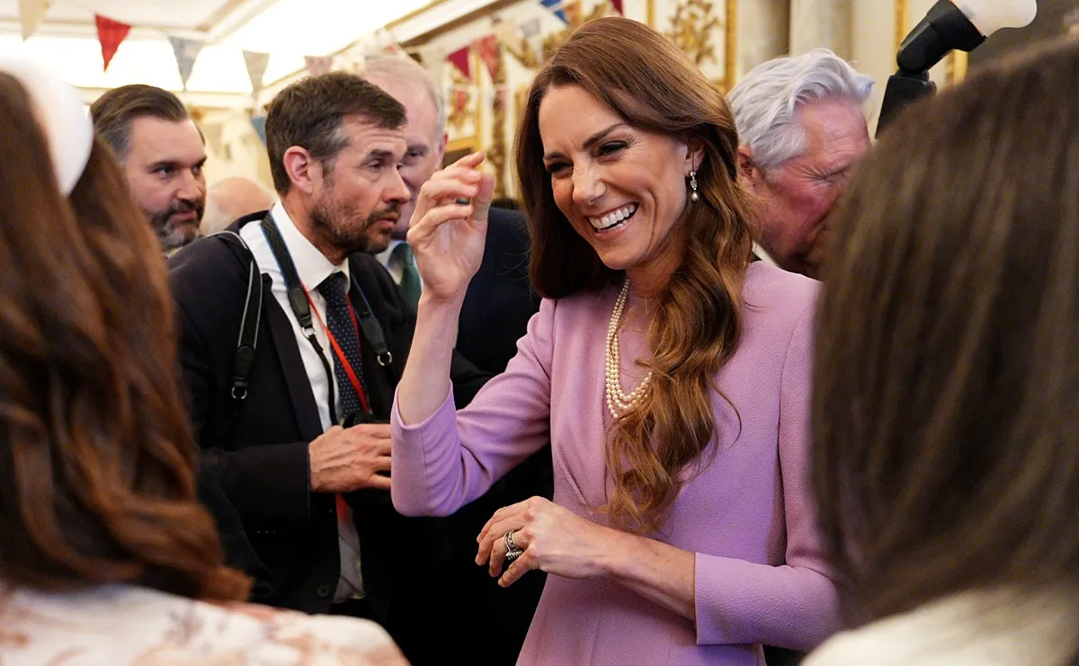 Kate Middleton talks with guests as she attends a reception at Buckingham Palace on the 100th anniversary of the birth of Queen Elizabeth II