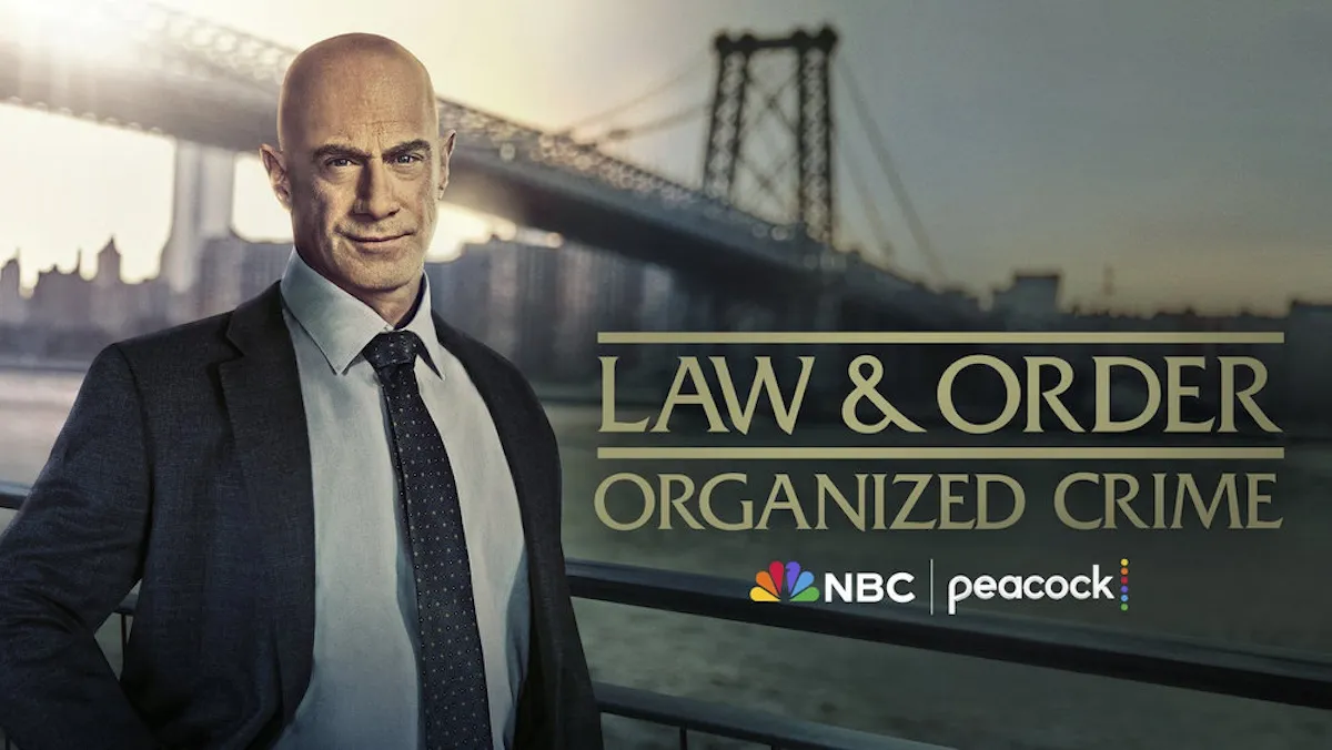 Chris Meloni standing in front of a backdrop of the Brooklyn Bridge in key art for 'Law & Order: Organized Crime'