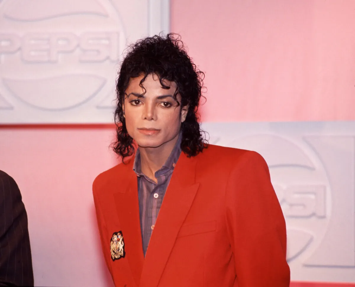 Michael Jackson wears a red blazer.