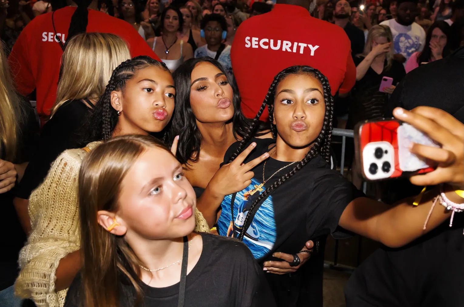Kim Kardashian, daughter North West, and friends pose for a photo during SZA's performance at the Summerfest Music Festival 2024