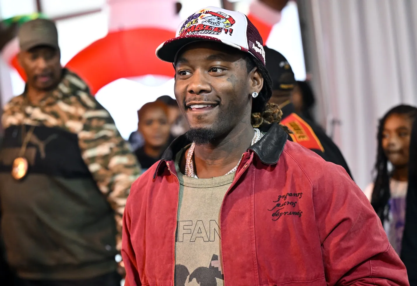 Rapper Offset wearing a baseball cap and red jacket at the Toys 4 The Nawf Christmas Charity event in 2025
