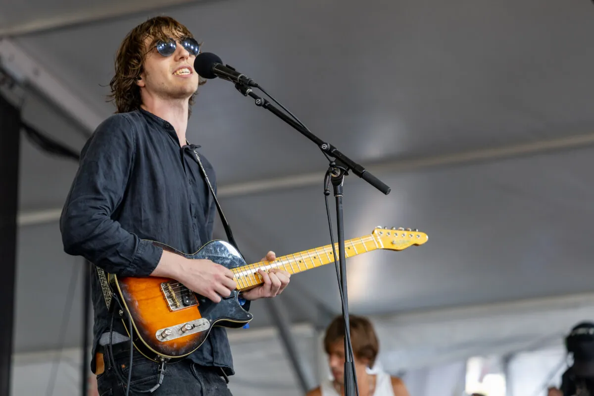 Cameron Winter, who recently went on a date with Olivia Rodrigo, wears black and plays guitar.