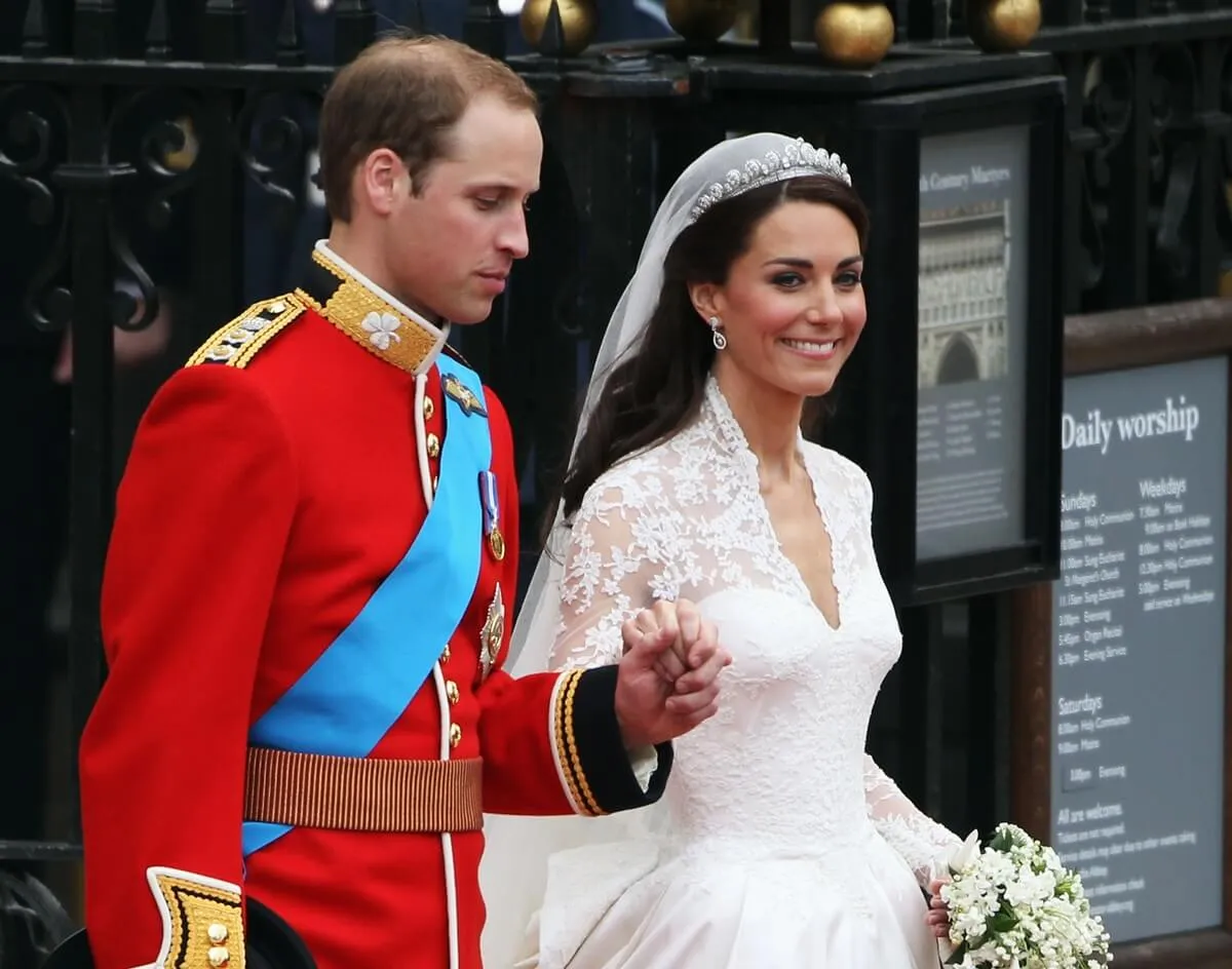 Prince William and Kate make the journey by carriage procession to Buckingham Palace following their marriage at Westminster Abbey