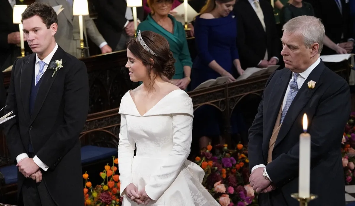 Princess Eugenie and Jack Brooksbank stand at the alter with Andrew Mountbatten-Windsor during their wedding ceremony at St George's Chapel