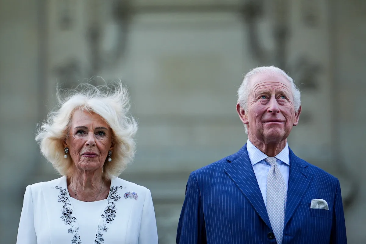 Queen Camilla, in white, and King Charles III, in blue suit