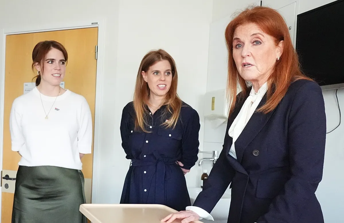 Sarah Ferguson and her daughters Princess Beatrice and Princess Eugenie speak with a patient at the Teenage Cancer Trust unit at University College Hospital, London