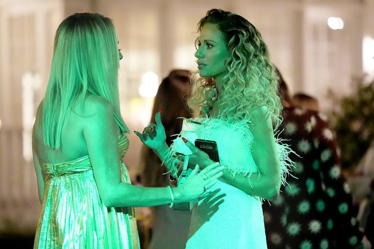 Sutton Stracke talks to Dorit Kemsley at a party in 'RHOBH'