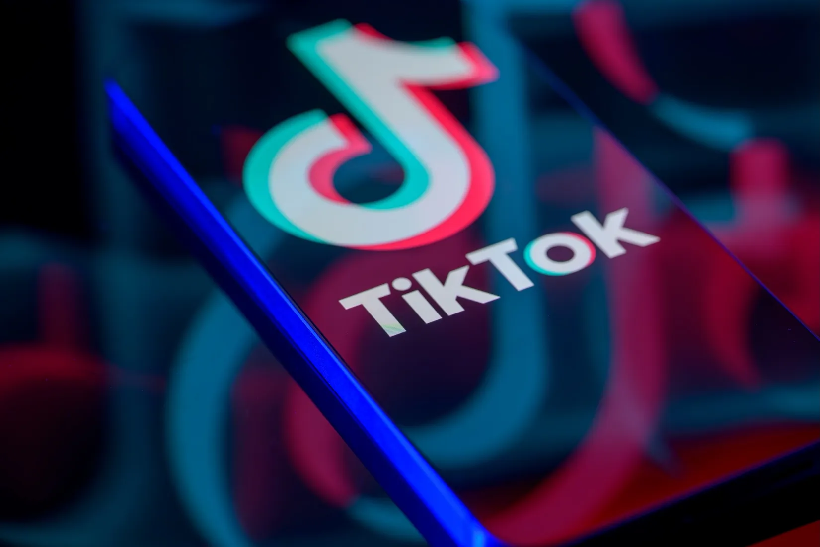 The TikTok logo is displayed on a smartphone screen in this photo illustration