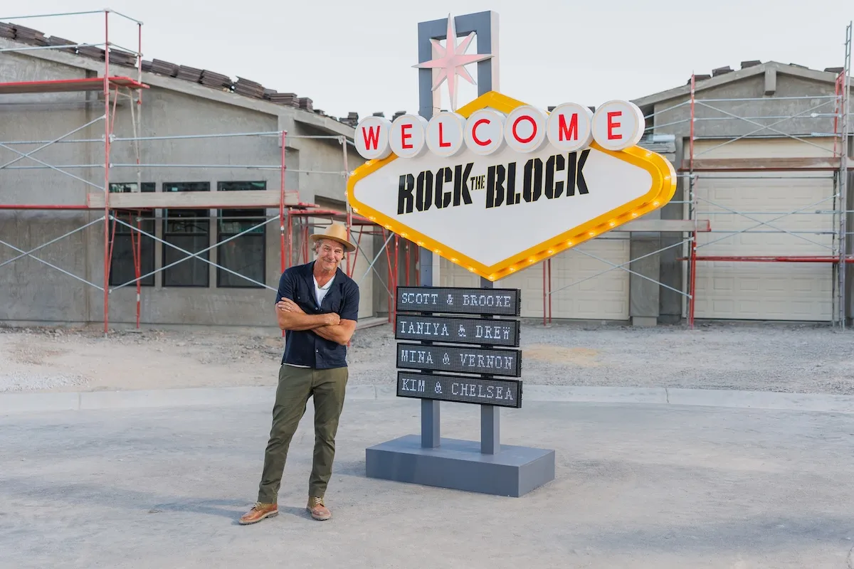Ty Pennington standing in front of Rock the Block sign in style of the Welcome to Vegas sign