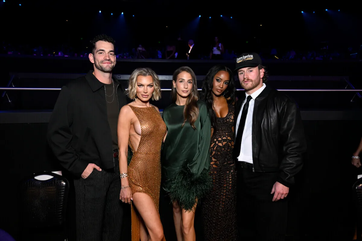 Lindsay Hubbard, Amanda Batula, Ciara Miller, and West Wilson pose together. Hubbard wears brown and Batula wears green. Solomon, Miller, and Wilson wear black.