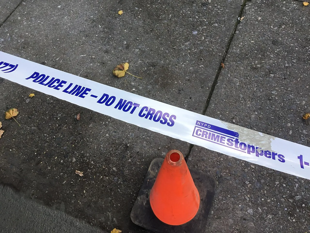 Crime scene tape is seen on the street