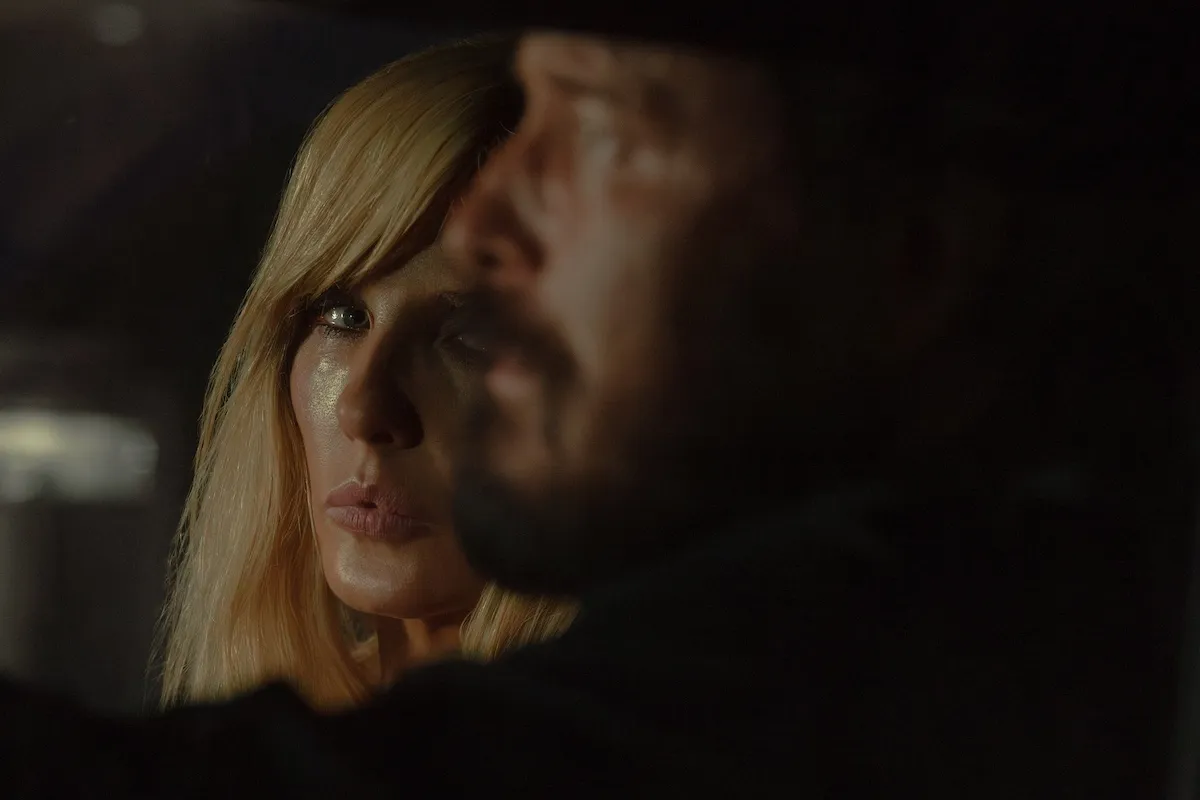 Beth Dutton looking at Rip Wheeler, whose face in in profile, in 'Dutton Ranch'