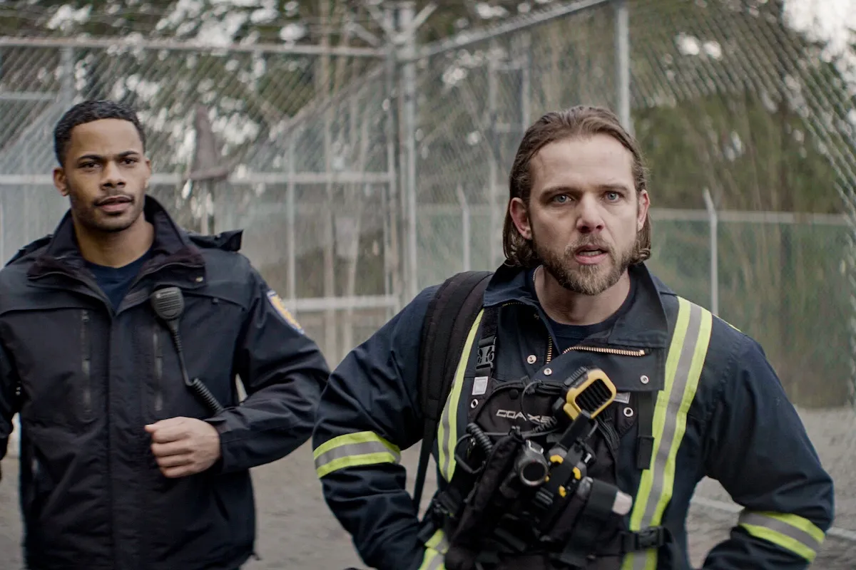 Jake and Bode running while wearing firefighting gear in 'Fire Country' Season 4
