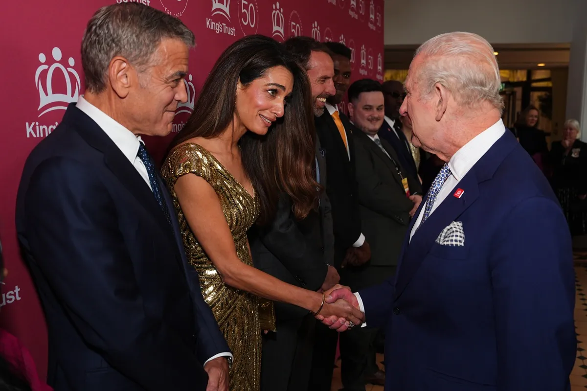George Clooney looks on as King Charles III meets Amal Clooney