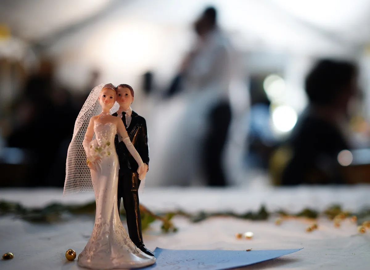 Bride and groom figurines are pictured on a table during a wedding party on september 13, 2014