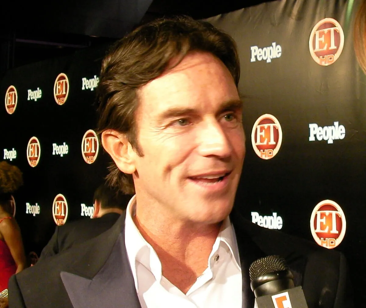 Jeff Probst speaks into a microphone.