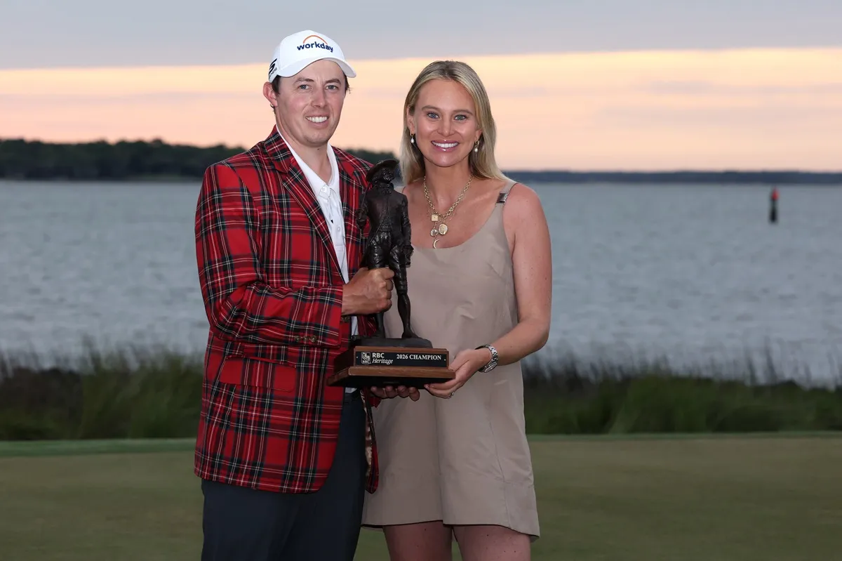 Matthew Fitzpatrick of England and wife, Katherine, pose with the winner's trophy after winning the RBC Heritage 2026
