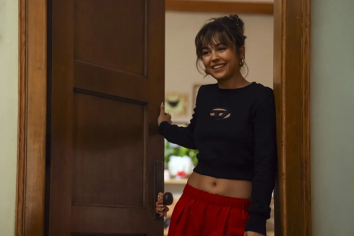 Young woman leaning against a door in 'Off Campus'
