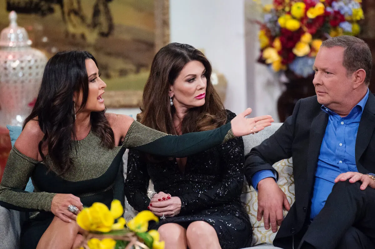 Kyle Richards, Lisa Vanderpump, and PK Kemsley sit on a couch together.
