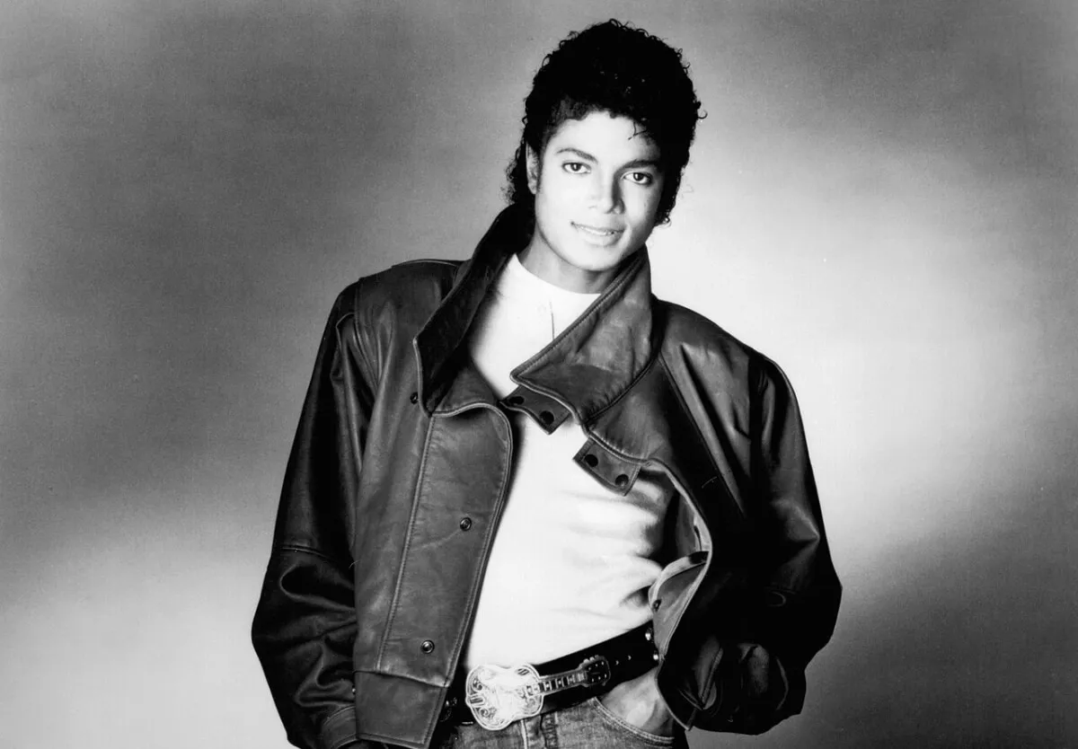 A black and white picture of Michael Jackson wearing a leather jacket.
