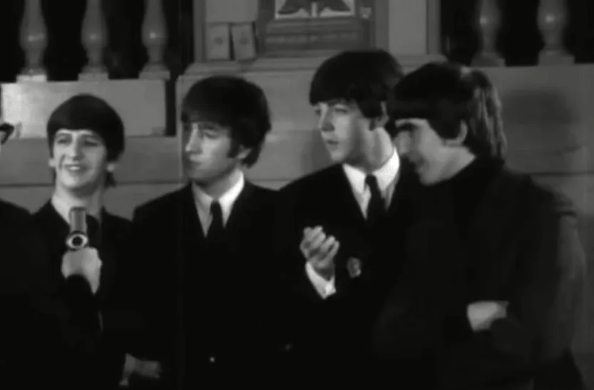 A black and white picture of Ringo Starr, John Lennon, Paul McCartney, and George Harrison of The Beatles wearing suits.