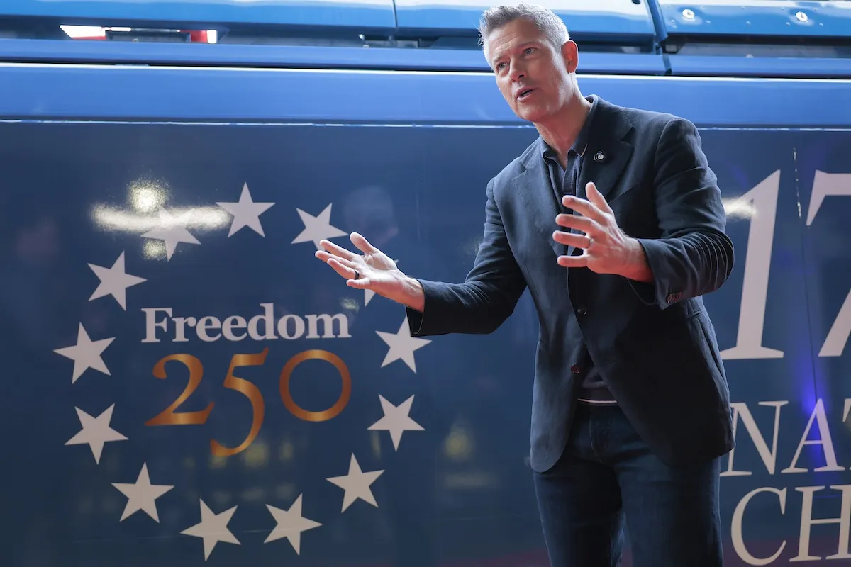Transportation Secretary standing in front of 'Freedom 250' train