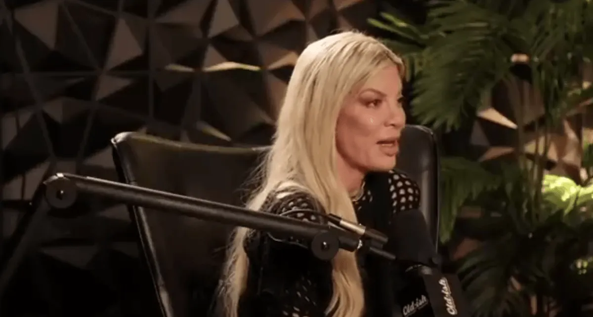 Tori Spelling speaking into a microphone