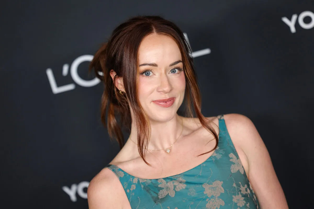 'Mormon Wives' star Whitney Leavitt wears a blue floral dress and smiles.