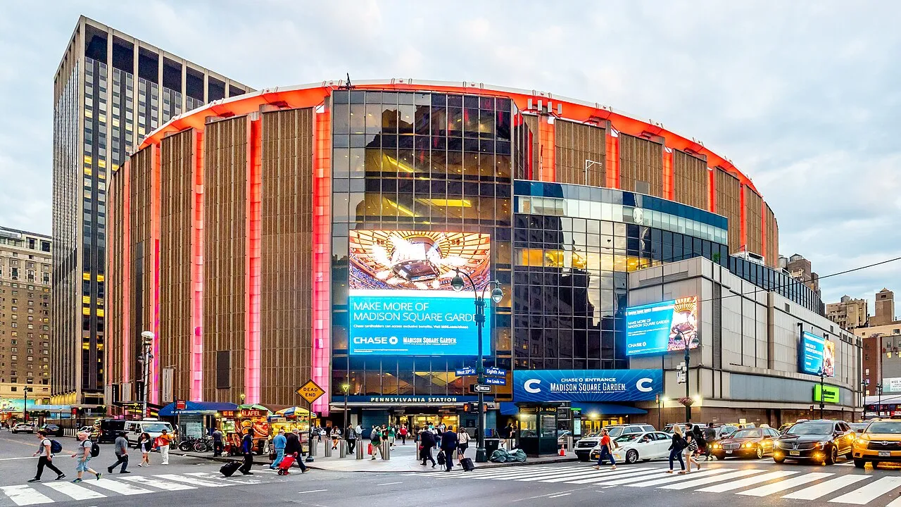 The outside of Madison Square Garden with people around it.