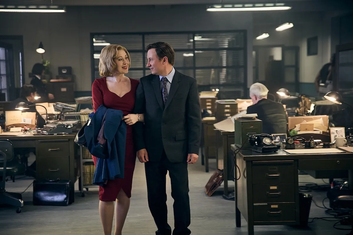 Miss Scott (Melissa Johns) and Larry (Bradley Hall) walking through the police station in 'Grantchester' Season 11