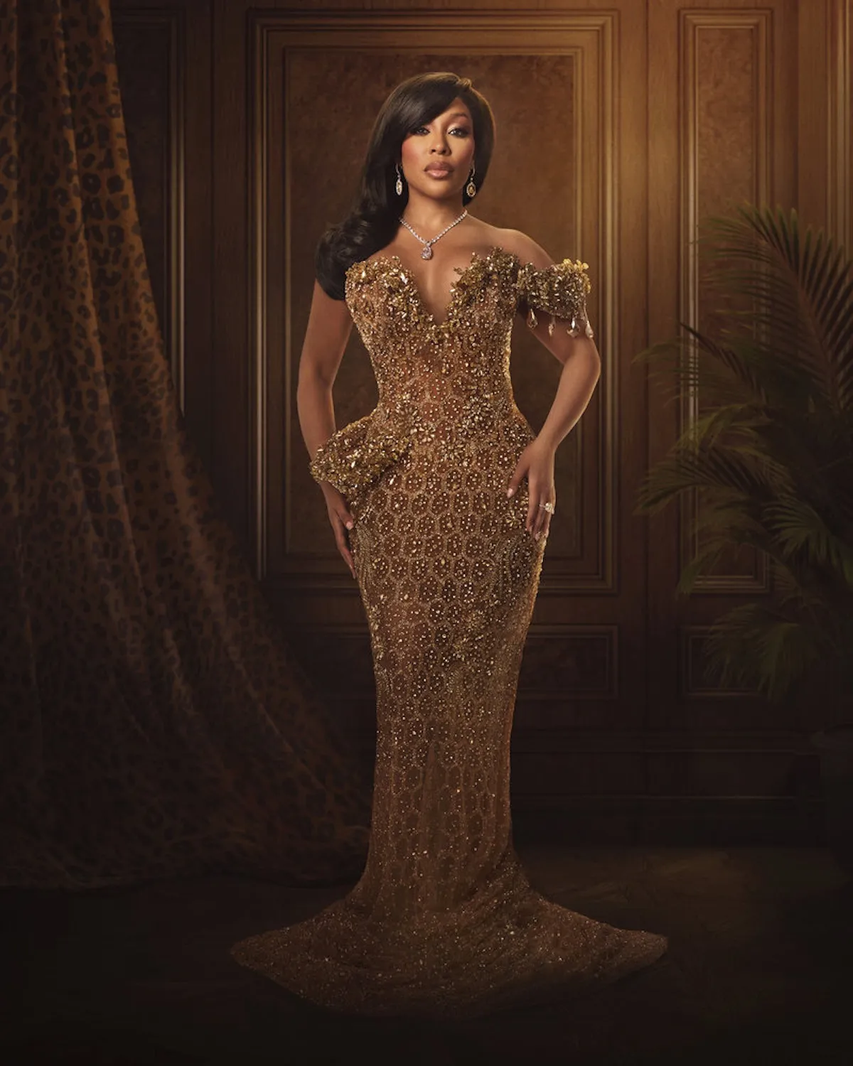 Full-length portrait of K. Michelle in a gold gown for 'The Real Housewives of Atlanta'