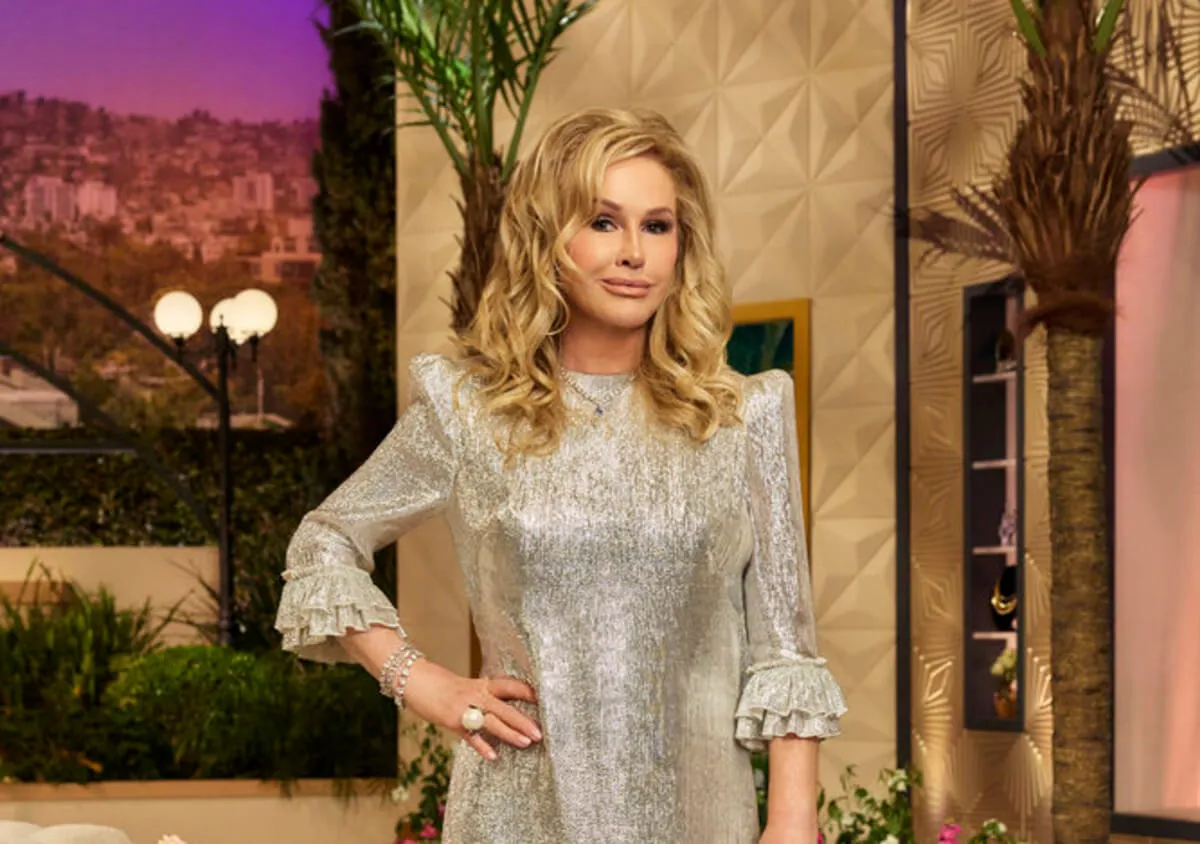 Kathy Hilton wears a silver dress and stands with her hand on her hip.