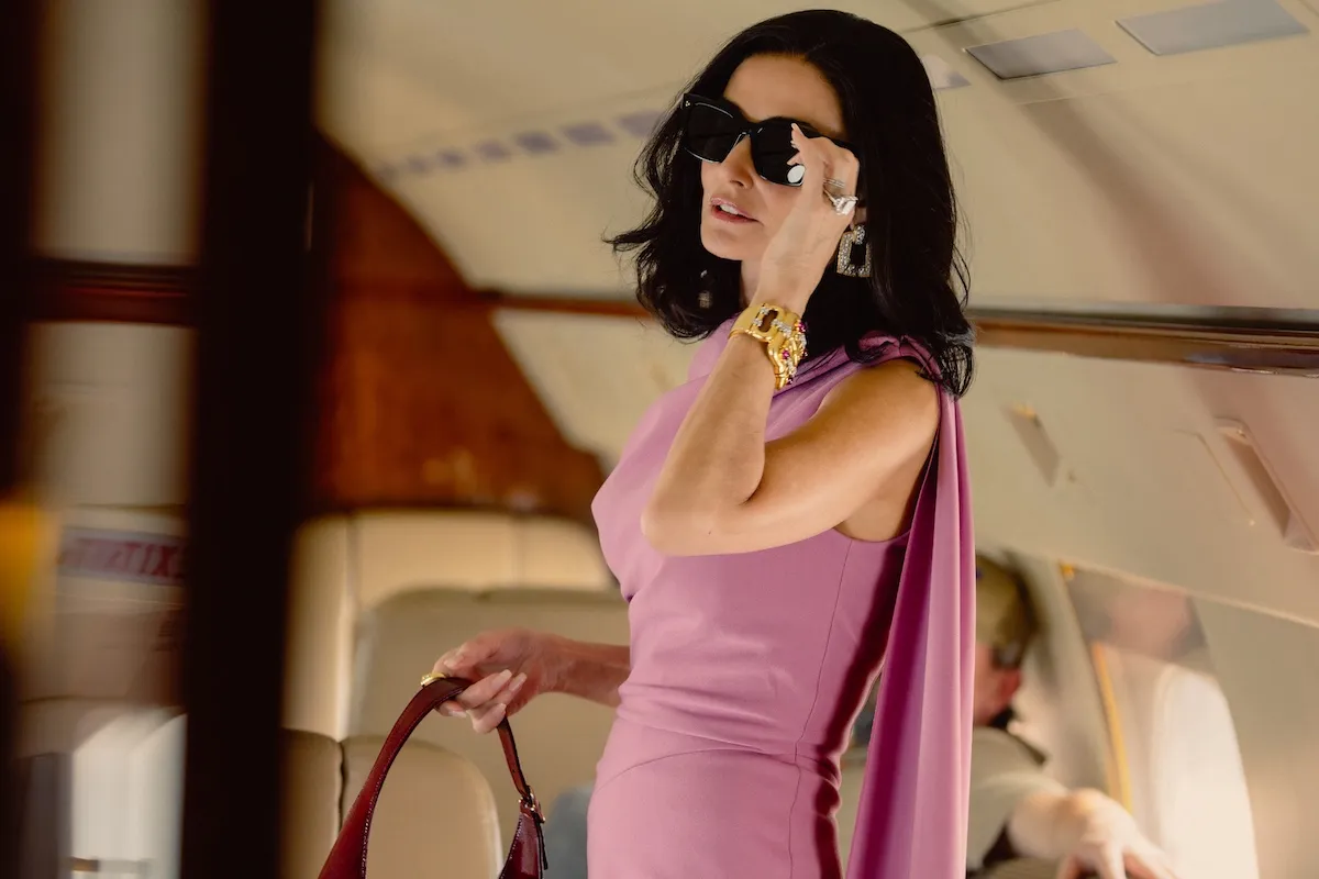Demi Moore, wearing a pink dress and sunglasses, in 'Landman' Season 2