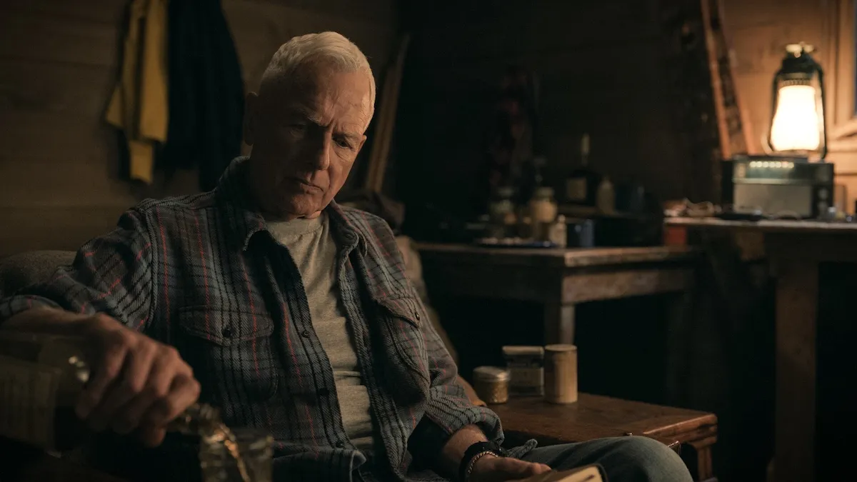 Mark Harmon sitting in a cabin in 'NCIS'