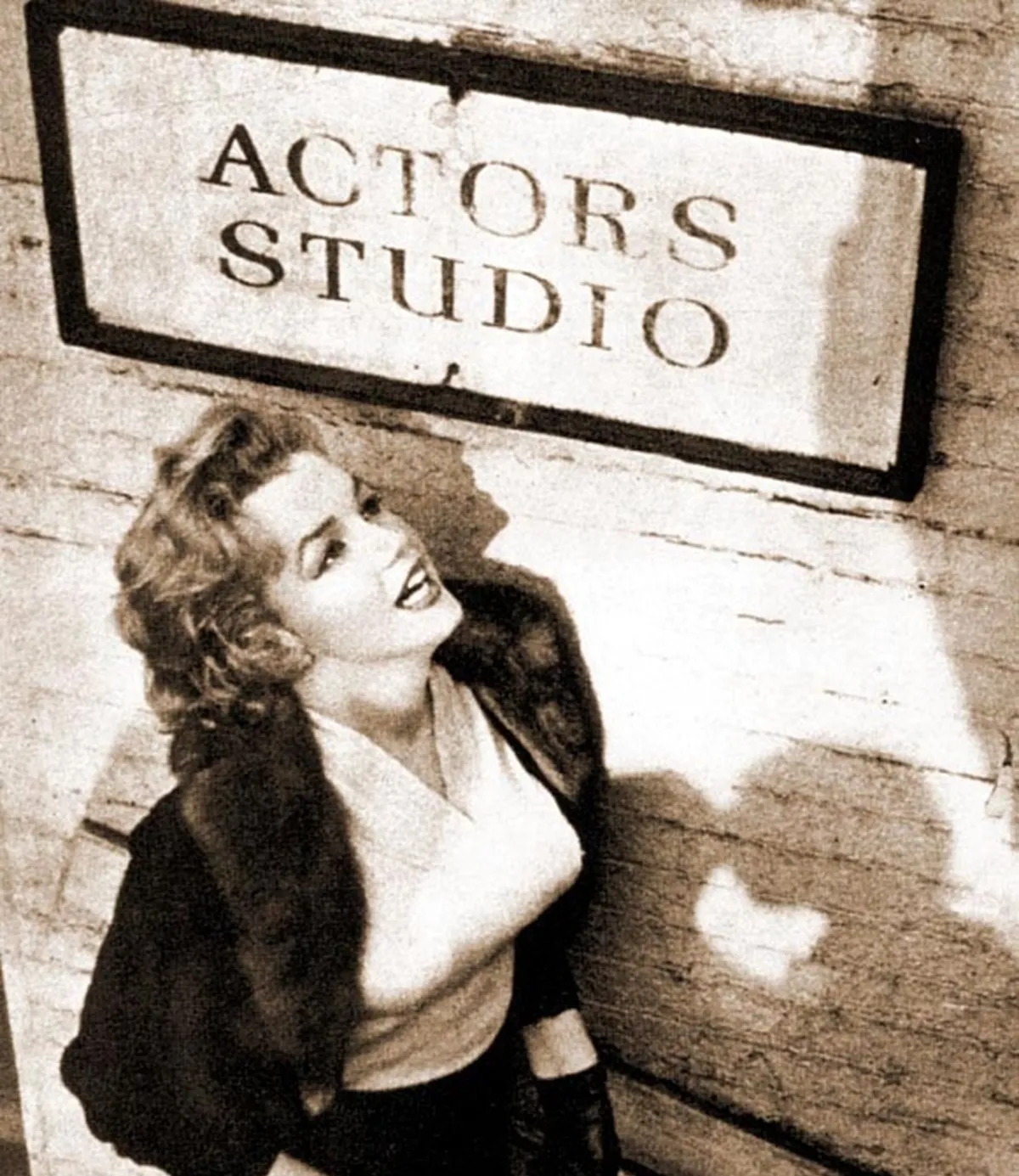 Marilyn Monroe seen in front of a 'Actors Studio' sign a year before her often-questioned death.