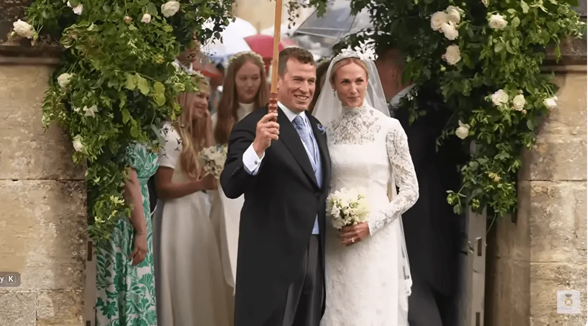 Screenshot of Peter Phillips posing with his bride, Harriet Sperling, following their wedding ceremony
