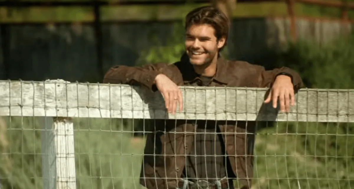 Sean from 'Farmer Wants a Wife' Season 4 leaning on a fence
