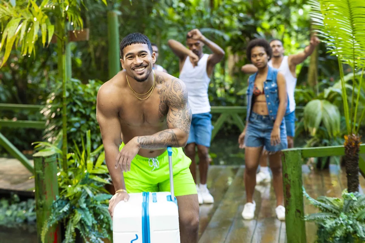 Sean Reifel of 'Love Island USA' Season 8 leaning on his suitcase and wearing lime green shorts