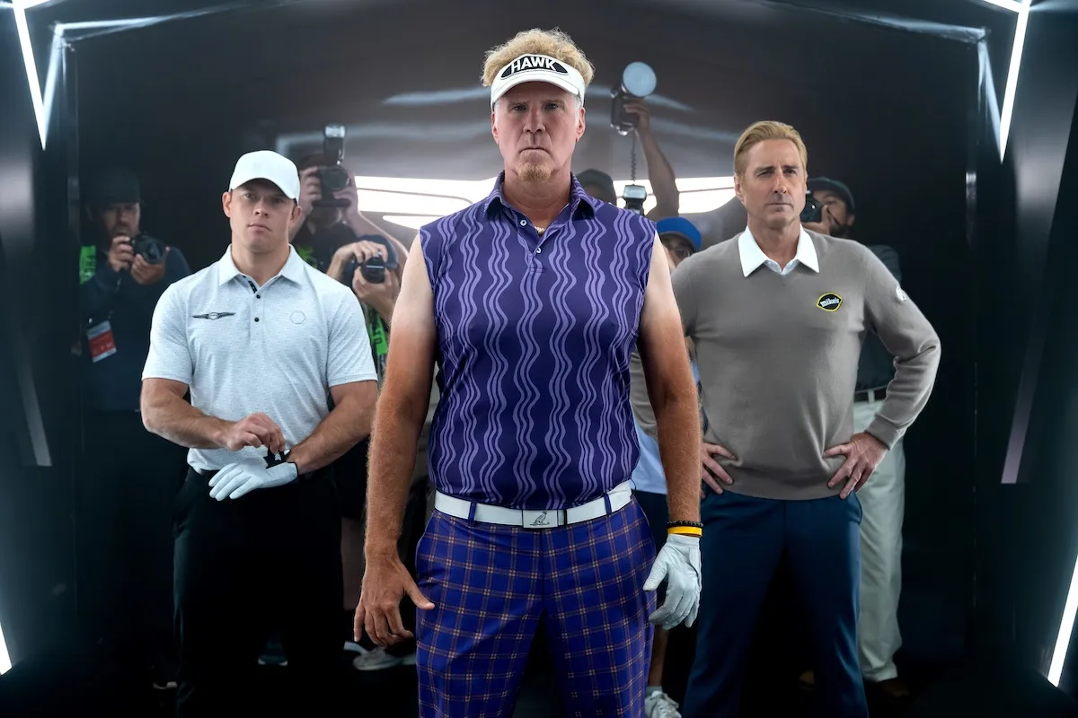 Will Ferrell (center) wearing a sleeveless purple shirt and sun visor in the 'The Hawk'