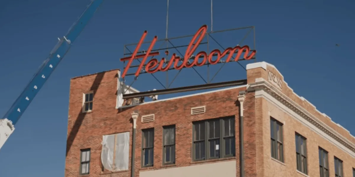 Sign being placed on The Heirloom Hotel in Laurel, Mississippi