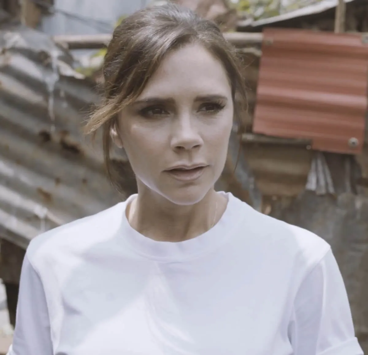 Victoria Beckham wears a white shirt.