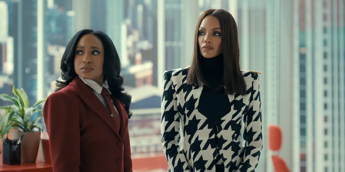 Kimmie and Mallory standing in front of a wall of windows in 'Beauty in Black' Season 3
