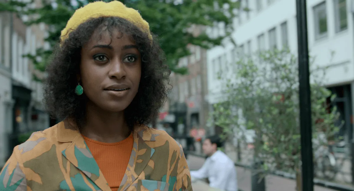 Black woman wearing a yellow knit hat in the Netflix series Behind Her Eyes