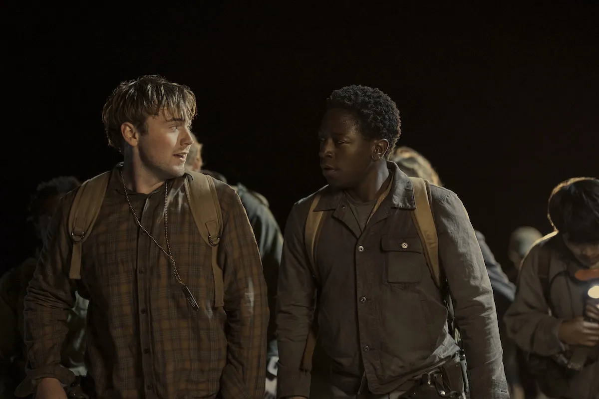 David Jonsson looking at Cooper Hoffman in a night scene from the 2025 movie 'The Long Walk'