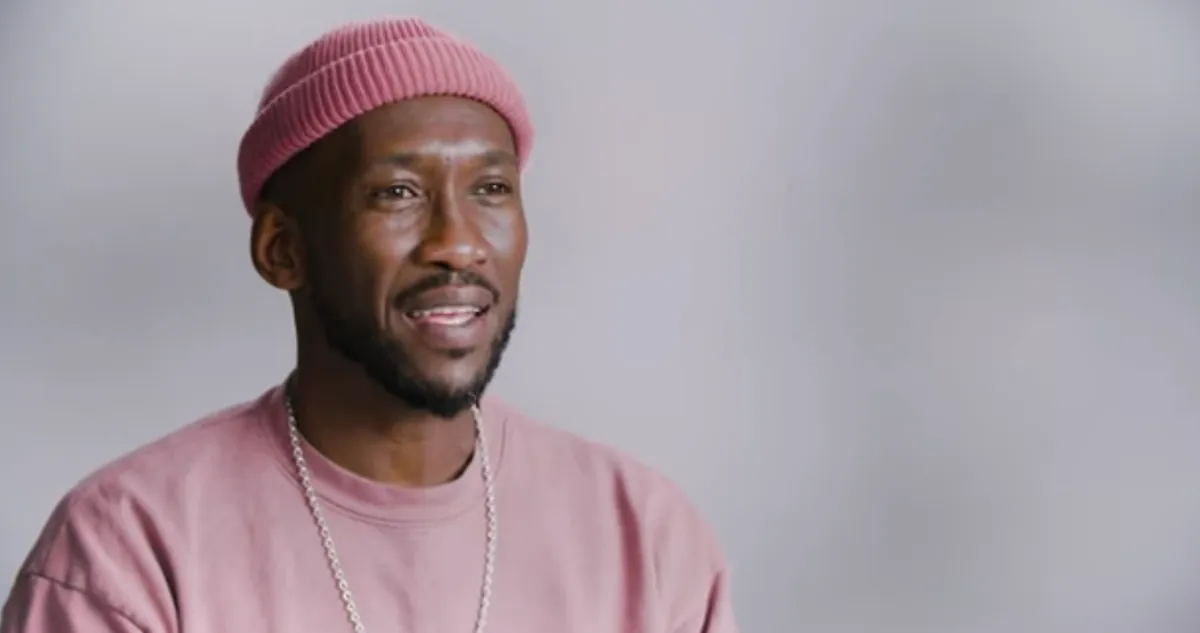 Mahershala Ali wearing a pink beanie