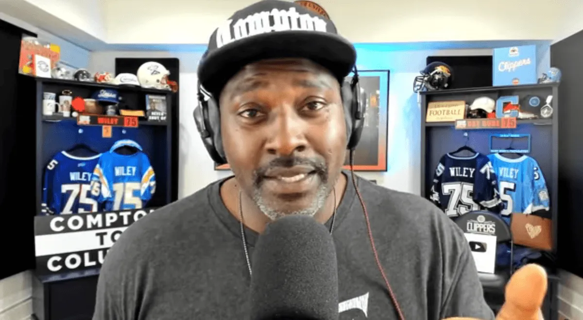 Marcellus Wiley speaking into a microphone during a YouTube livestream