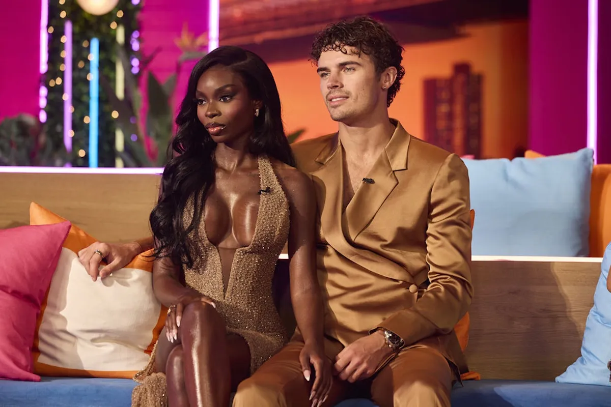 Olandria and Nic from 'Love Island USA' sitting on the couch at the season 7 reunion