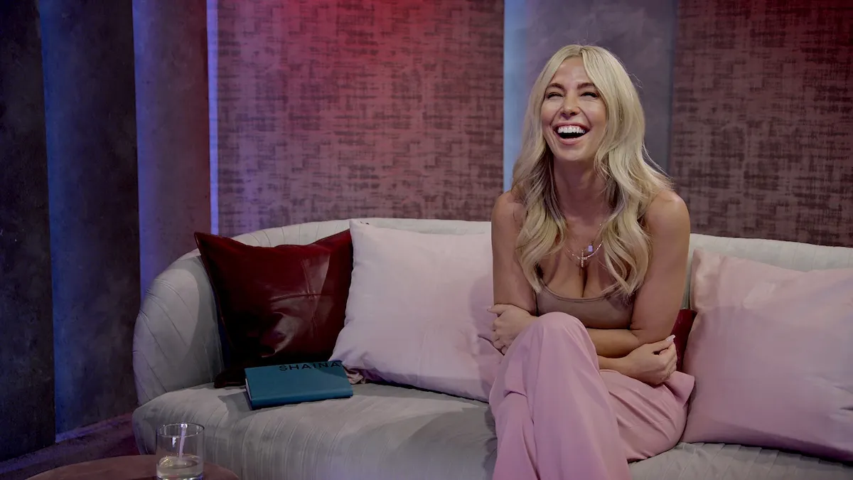 Laughing Shaina sitting on a couch in 'Love Is Blind' Season 2