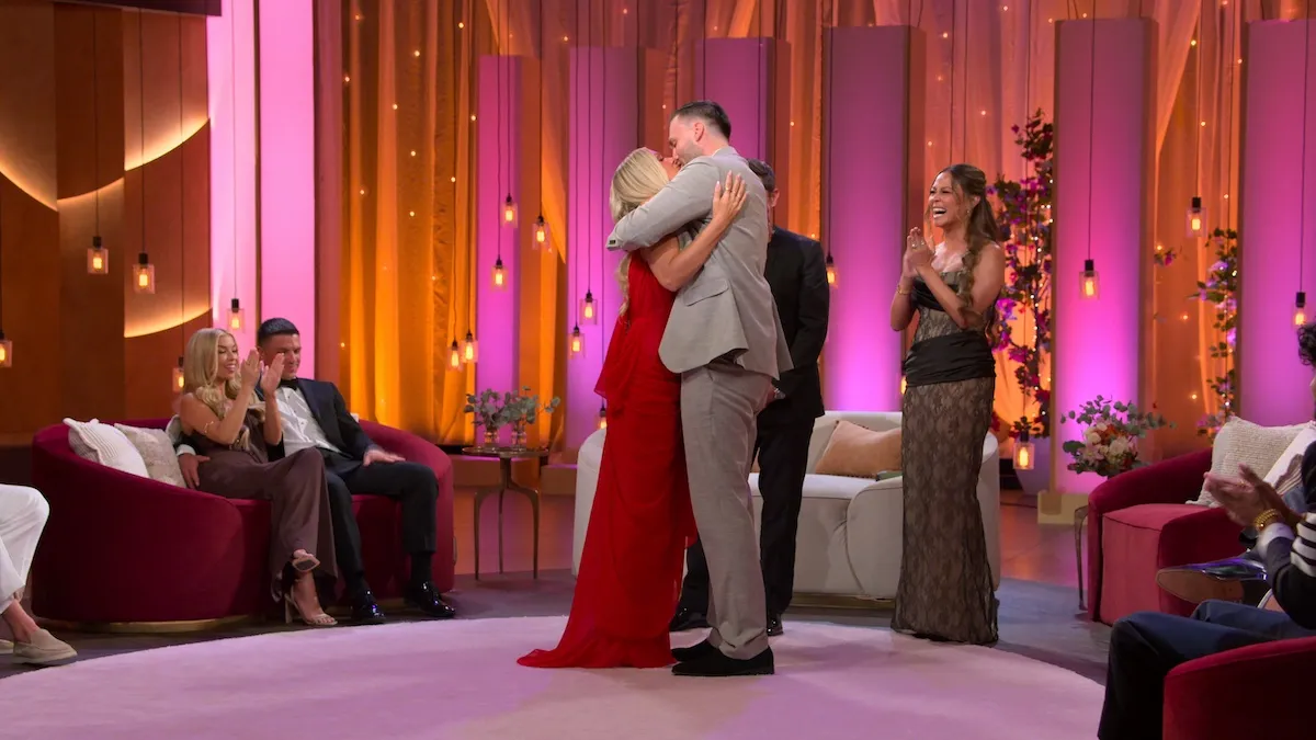 A couple embraces on stage at 'The Ultimatum: Season 4' reunion