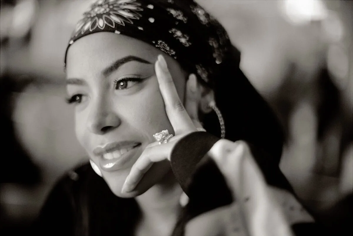 A black and white picture of Aaliyah with a bandana over her hair.